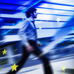 PHotograph of business person moving at blurring speed. Office and stars in the background